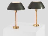a pair of black lamps sitting on top of a white table