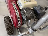 a small red motorcycle with a small engine in a room