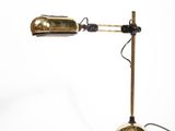 an image of a gold desk lamp on a white background