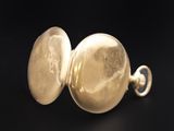 an image of a close up of a gold locke on a black background