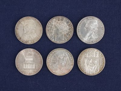 six different british coins on a blue cloth