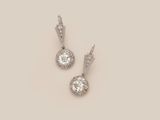 a pair of diamond and white gold earrings