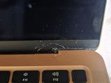 a broken laptop computer sitting on a table