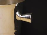 a metal pipe sticking out of a wall next to a toilet