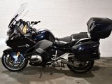 a black motorcycle parked in a room with a checkered floor