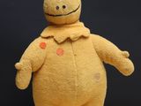 a yellow stuffed animal that is standing on a table