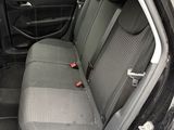 a black car with a gray seat cover in the back of it