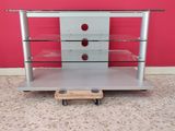 an image of a silver tv stand with glass shelves and wheels