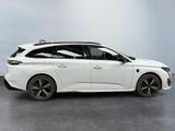 a white car with black rims parked in a room