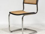 une image représentant une chaise avec une assise en osier sur une structure métallique
