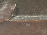 a bronze statue of a man sitting on a bench