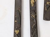three knives that are sitting on a table