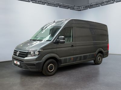 the van is parked in a large room with a white wall in the background