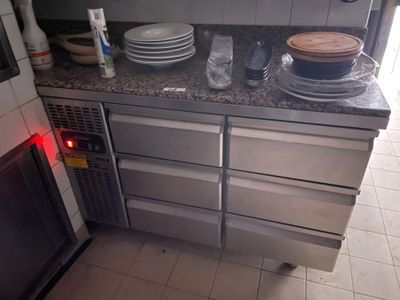 many plates and pans on the counter in the kitchen