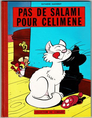 a book with a cat sitting on the floor next to a mouse