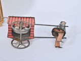 a small toy horse pulling a cart with a man on it