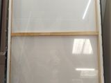 two pieces of glass are sitting on a shelf in a box