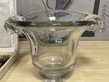 a glass vase sitting on a table next to a pair of scissors