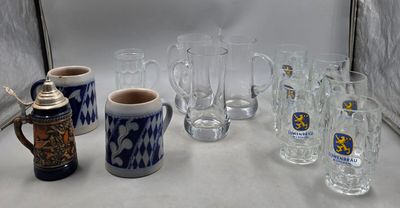 many glasses and mugs sitting on a table