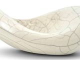 a white bowl that is sitting on a white surface