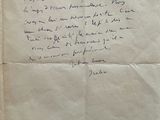 an old piece of paper with writing on it sitting on a table