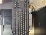 a computer keyboard sitting on top of a computer desk