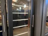 a large glass door that is open in a room