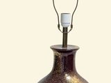 a lamp that is sitting on a table next to a wall