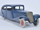 a toy model of a blue car on a white surface