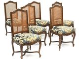 un ensemble de quatre chaises de salle à manger de style Louis II à dossier en rotin