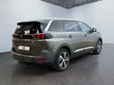 the rear end of a grey suv parked in a garage