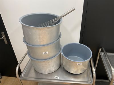 three buckets and a whisk on a metal cart