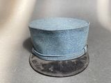 a blue hat sitting on top of a coin on a table