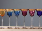 six wine glasses are lined up in a row on a table