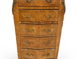 an old wooden chest of drawers with a marble top