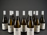 six bottles of wine are lined up in a row on a table