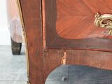 a wooden cabinet with a drawer on top of it