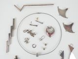 a white table topped with various metal items on it