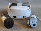 un casque VR blanc et noir et deux télécommandes