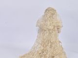 bride figurine with veil and veiled dress sitting on a white surface
