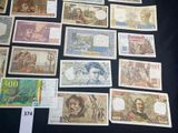 a lot of different foreign currency on the table