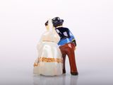 a figurine of a man and a woman standing next to each other