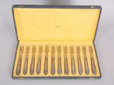 six forks and a spoon in a case