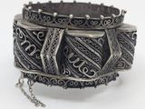 an image of a silver bracelet with a chain on a white background
