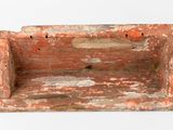 an old wooden box with a hole in it
