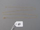 two gold necklaces and a tag with the number 66 on them