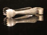 two spoons and a fork on a black surface