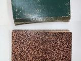 two pieces of green and brown soap sitting on top of a white surface