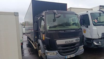 two trucks parked next to each other in a parking lot