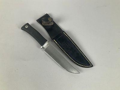 two knives are laying next to each other on a white surface